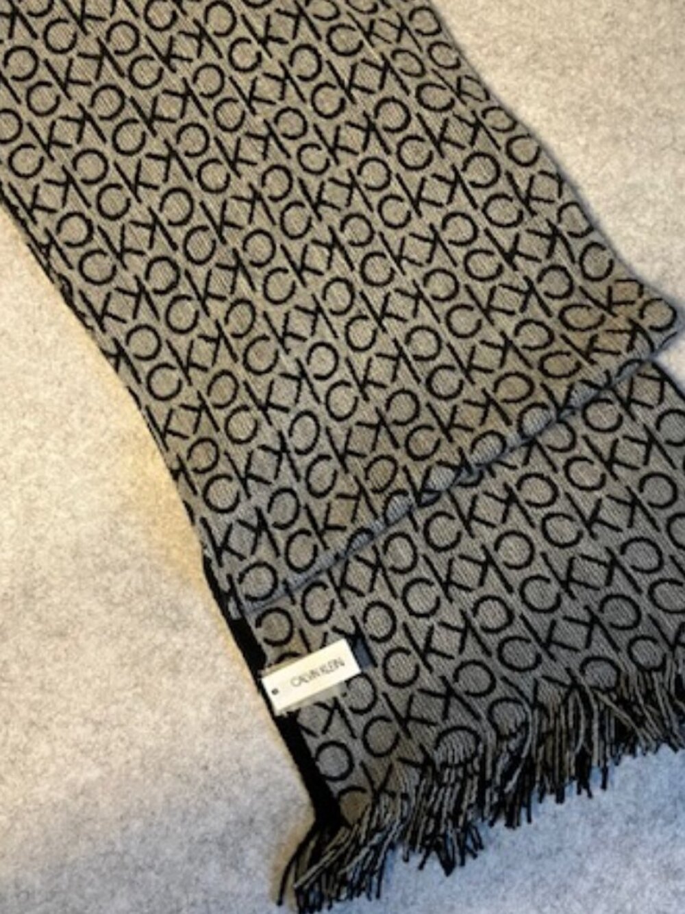 Calvin Klein knit scarf featuring black and grey design.